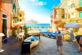 Summer day as tourists walk towards the boat launch of Riomaggiore, Italy, on the Cinque Terre.