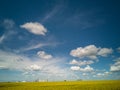 Yellow fields under the clouds in the blue sky