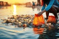 Summer day cleanup: Human hands gather waste on the beach