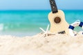 The Summer day with Guitar ukulele items travel for relax and chills on the beautiful beach and blue sky background,copy space