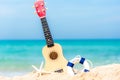 The Summer day with Guitar ukulele for relax on the beautiful beach and blue sky background,