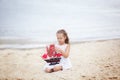 Summer day. Happy childhood carefree game on the open sand. The concept of rest. Girl on the sea with a ship. portrait of the girl Royalty Free Stock Photo