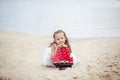 Summer day. Happy childhood carefree game on the open sand. The concept of rest. Girl on the sea with a ship. portrait of the girl Royalty Free Stock Photo