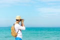 Summer Day. Happy smiling caucasian tourist asian young man holding camera Royalty Free Stock Photo