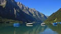 Summer day at lake Klontalersee, Switzerland. Fishing boats. Glaernisch, mountain range. Royalty Free Stock Photo