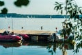 Summer day on the lake, river, white sport sailing yachts. Inflatable motor boat near the pie