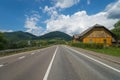 Summer day landscape with forest, cloudy sky and road. Royalty Free Stock Photo