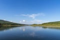 Summer day landscape with river, forest, clouds on the blue sky and sun. Royalty Free Stock Photo