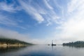 Summer day landscape with river, forest, clouds on the blue sky and sun. Royalty Free Stock Photo