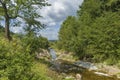 Summer day landscape with river, forest and cloudy sky Royalty Free Stock Photo