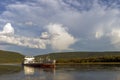 Summer day landscape with river, forest and cloudy sky and tanker Royalty Free Stock Photo