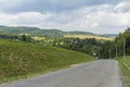 Summer day landscape with road, cloudy sky and Carpathian Mountains Royalty Free Stock Photo