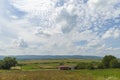 Summer day landscape with road, cloudy sky and small houses. Ukraine, Carpathian. Royalty Free Stock Photo