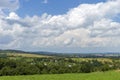 Summer day landscape with road, cloudy sky and small houses. Ukraine, Carpathian. Royalty Free Stock Photo