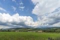 Summer day landscape with road, cloudy sky and small houses. Ukraine, Carpathian. Royalty Free Stock Photo