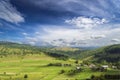 Summer day landscape with road, cloudy sky and small houses. Ukraine, Carpathian. Gogol, ancient. Royalty Free Stock Photo