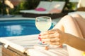 Summer day lifestyle woman relax near luxury swimming pool. Royalty Free Stock Photo