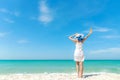 Summer Day. Lifestyle woman wearing white dress fashion summer beach on the sandy ocean beach. Happy woman enjoy and relax vacat