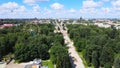 Summer day in little green town. Swallows and martlets fly over trees in park