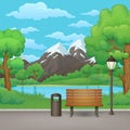 Summer day in the park. Wooden bench, trash can and street lamp with lake and mountains in the background.