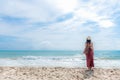 Summer Day. Smiling woman wearing fashion summer standing and see the sandy ocean beach. Happy woman enjoy and relax vacation. Royalty Free Stock Photo