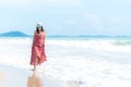 Summer Day. Smiling woman wearing fashion summer walking on the sandy ocean beach Royalty Free Stock Photo