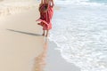 Summer Day. Smiling woman wearing fashion summer walking on the sandy ocean beach. Happy woman enjoy and relax vacation Royalty Free Stock Photo