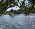 Summer day view at the River Siene through green trees and blue sky reflection and sparkling water surface Royalty Free Stock Photo