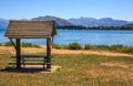 Summer day view of Shade shelter for tourists at Lake Wanaka, New Zealand with blue lake and mountain background Royalty Free Stock Photo