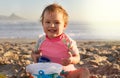 Summer days are best spent at the beach. Portrait of an adorable little girl playing in the sand at the beach. Royalty Free Stock Photo