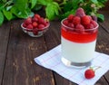 Summer dessert with cream and raspberry jelly, decorate with fresh berries in a transparent glass Royalty Free Stock Photo