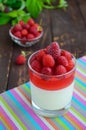 Summer dessert with cream and raspberry jelly, decorate with fresh berries in a transparent glass Royalty Free Stock Photo