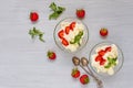 Summer dessert with sliced strawberries and cream cheese in the glass bowls on a gray background with copy space. Parfait Royalty Free Stock Photo