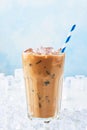 Summer drink ice coffee with cream in a tall glass with straw