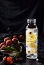 Summer drink made of lychees and lemons, marble table top, dark indoor background