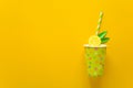 Summer drink with paper cut lemon slices and leaves on yellow paper background. Summer drink concept. Royalty Free Stock Photo