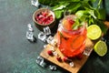 Summer drinks, bar soft beverage. Refreshing glasses drink raspberry with mint lime and ice on a dark stone table. Copy space. Royalty Free Stock Photo