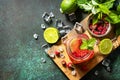 Summer drinks, bar soft beverage. Refreshing glasses drink raspberry with mint lime and ice on a dark stone table. Top view. Royalty Free Stock Photo