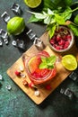 Summer drinks, bar soft beverage. Refreshing glasses drink raspberry with mint lime and ice on a dark stone table. Top view. Royalty Free Stock Photo