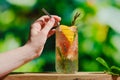 Hand with hard seltzer cocktail.