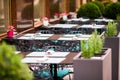 Summer empty open air restaraunt in italian city in Europe. Closeup wineglasses on the table