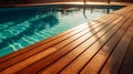 A summer escape comes to life as an empty wooden surface meets a shimmering hotel swimming pool