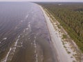 Summer evening, coastline, deserted beach of the Gulf of Riga. Sandy beach and waves. Photo from a drone