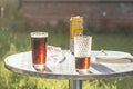 Summer evening. Colored drinks in various glassware on the outdoor table, a party in the backyard house with cold drinks, A set