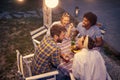 Summer evening in the garden, a group of friends  have a good time smiling together around a table Royalty Free Stock Photo