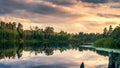 Summer evening landscape with red sunset on Ural lake with pine trees on the shore, Russia, August Royalty Free Stock Photo