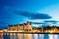 Summer evening view of the house on the citys waterfront, illuminated by night lights in Oslo, Norway. Royalty Free Stock Photo