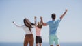 Summer family. Back view of happy young family walking on beach. Child with parents holding hands. Full length poeple. Royalty Free Stock Photo