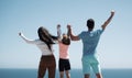 Summer family. Back view of happy young family walking on beach. Child with parents holding hands. Full length poeple. Royalty Free Stock Photo