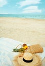summer fashion beach accessories and fresh fruit on sandy beach against blue sea and sky Royalty Free Stock Photo